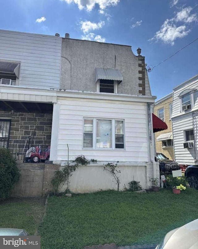 view of home's exterior with cooling unit and a lawn