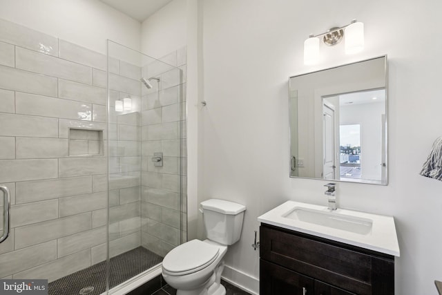 bathroom featuring vanity, toilet, and an enclosed shower