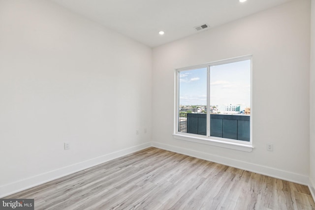 empty room with light hardwood / wood-style flooring