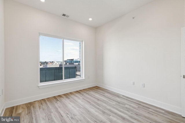 empty room with light hardwood / wood-style floors