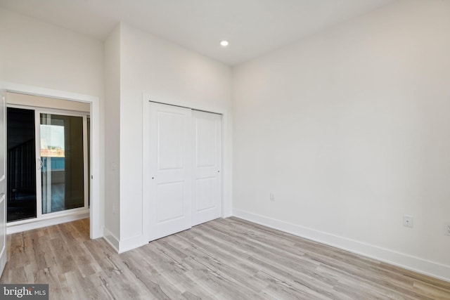 unfurnished bedroom featuring a closet and light hardwood / wood-style floors