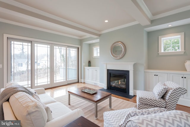 living room featuring light wood-type flooring, crown molding, and plenty of natural light