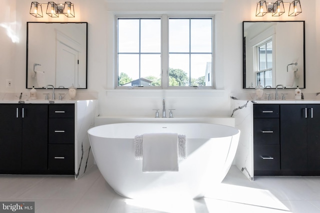 bathroom featuring a bath, tile patterned flooring, and vanity