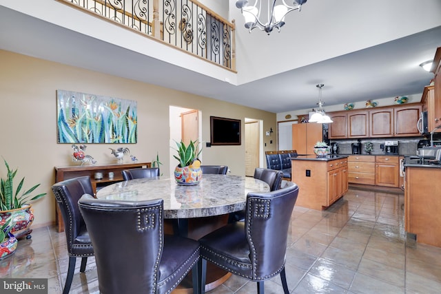 dining room featuring an inviting chandelier and a high ceiling