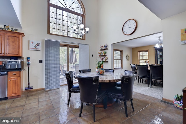 tiled dining space featuring a notable chandelier, a high ceiling, and plenty of natural light