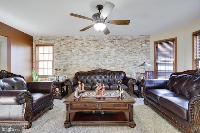 carpeted living room with ceiling fan