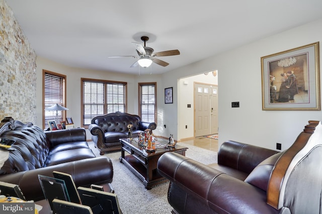 living room with ceiling fan and light tile patterned flooring