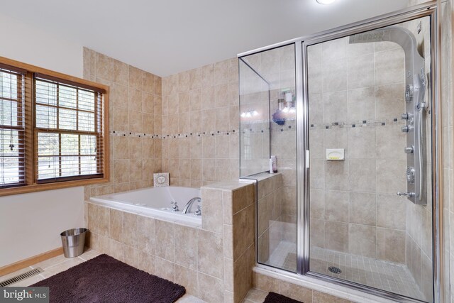 bathroom featuring plus walk in shower and tile patterned floors