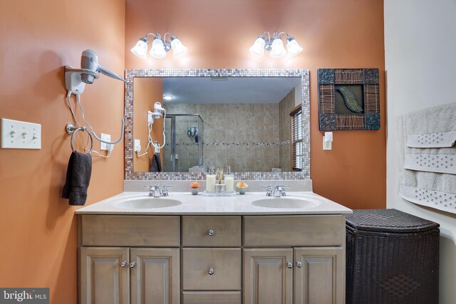 bathroom with tiled shower and vanity