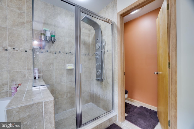 bathroom with tile patterned floors and an enclosed shower