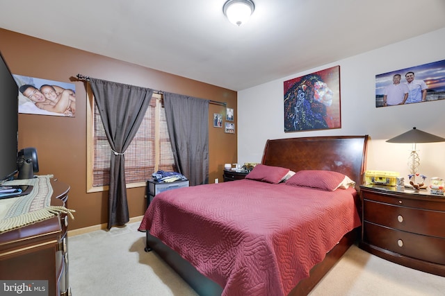 bedroom featuring light carpet