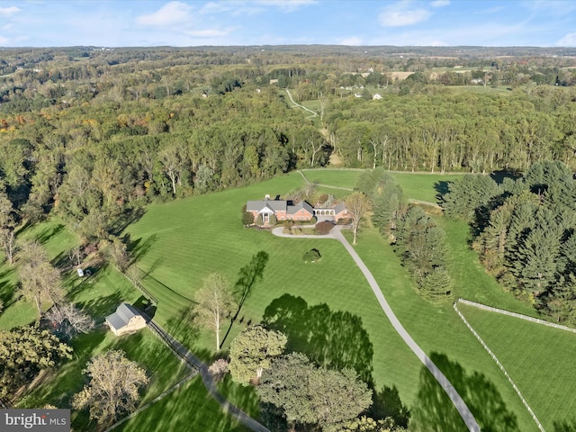 bird's eye view with a rural view and a wooded view