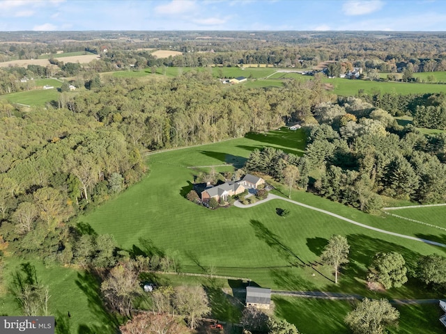 drone / aerial view with a wooded view