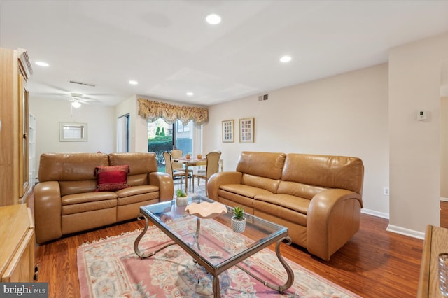 living room featuring hardwood / wood-style flooring and ceiling fan