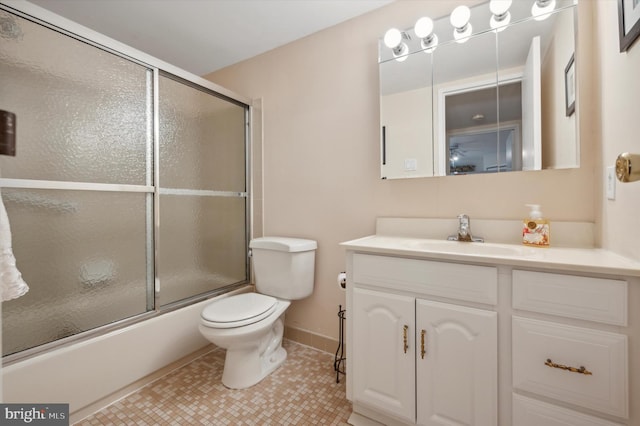 full bathroom featuring tile patterned floors, vanity, toilet, and bath / shower combo with glass door