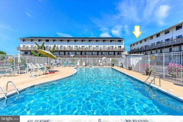 view of swimming pool with a patio area