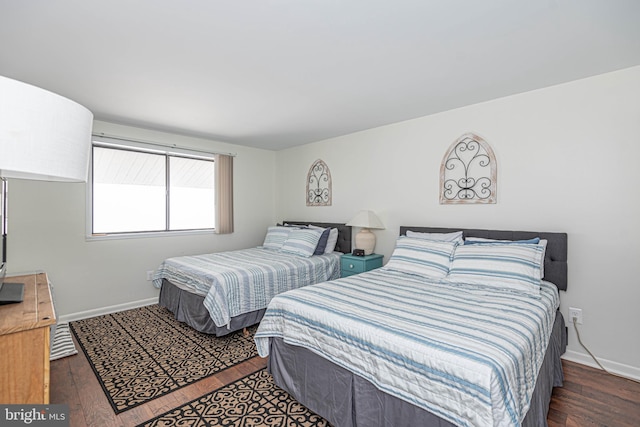 bedroom with dark hardwood / wood-style floors