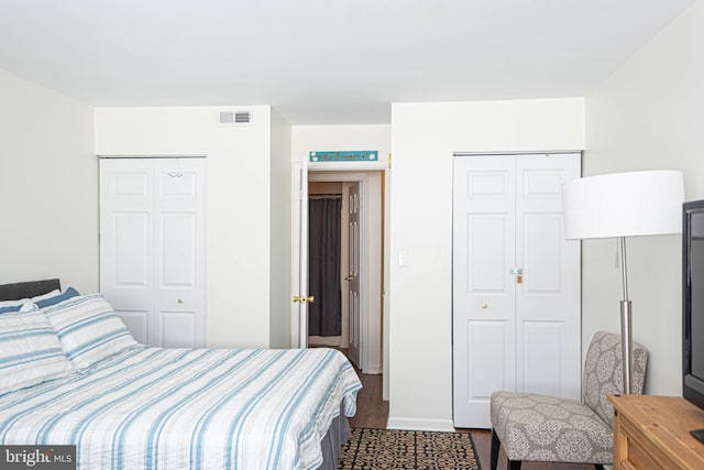 bedroom featuring dark wood-style floors, baseboards, and visible vents