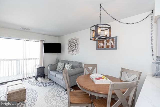 dining area featuring a notable chandelier