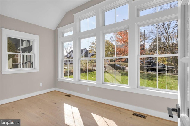 unfurnished sunroom with vaulted ceiling