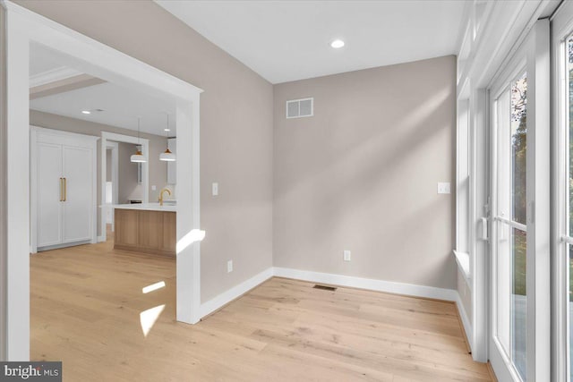 spare room with light wood-type flooring