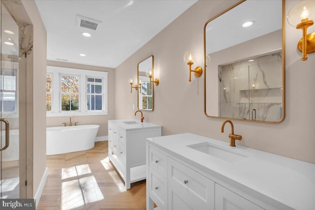 bathroom with vanity and independent shower and bath