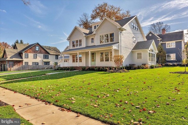 view of front of home featuring a front yard and covered porch