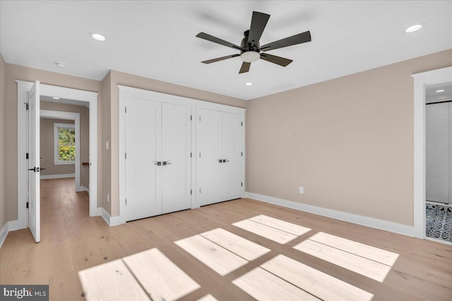 unfurnished bedroom with light wood-type flooring and ceiling fan