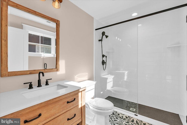 bathroom featuring vanity, an enclosed shower, and toilet