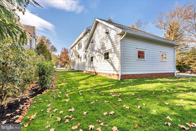 view of home's exterior with a lawn