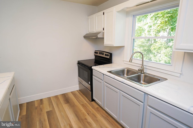 kitchen with white cabinetry, plenty of natural light, sink, and stainless steel range with electric cooktop