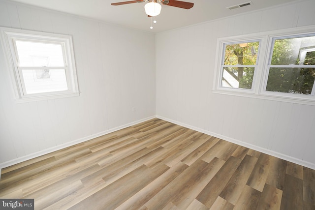 empty room with light hardwood / wood-style flooring and ceiling fan