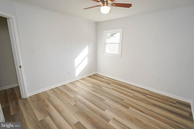 spare room featuring ornamental molding, hardwood / wood-style floors, and ceiling fan