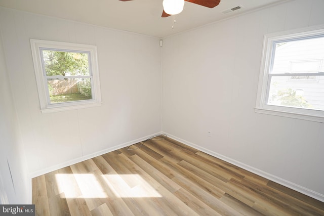 empty room with light wood-type flooring and ceiling fan