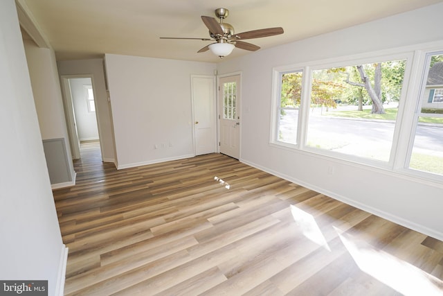 unfurnished room with ceiling fan and light hardwood / wood-style flooring