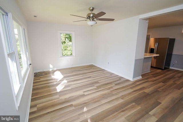 spare room featuring ceiling fan and light hardwood / wood-style flooring