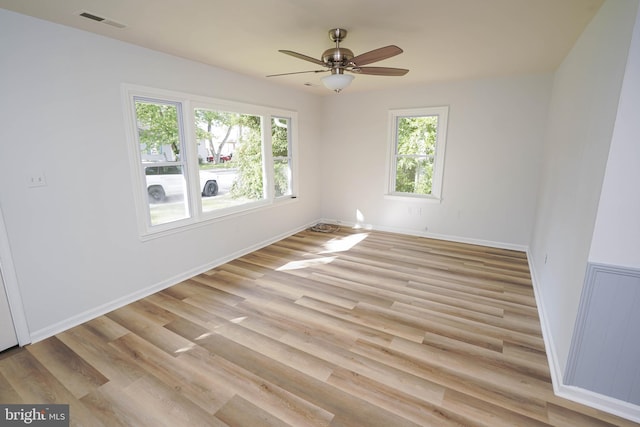 empty room with light hardwood / wood-style floors and ceiling fan