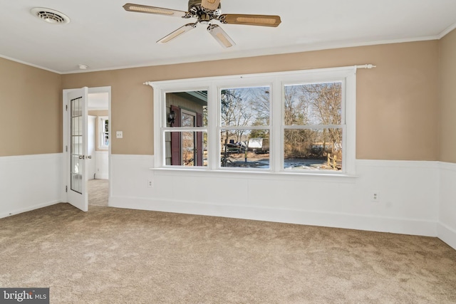 carpeted spare room featuring ornamental molding and ceiling fan