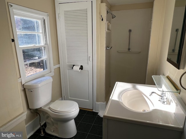 bathroom with tile patterned floors, vanity, toilet, and a shower