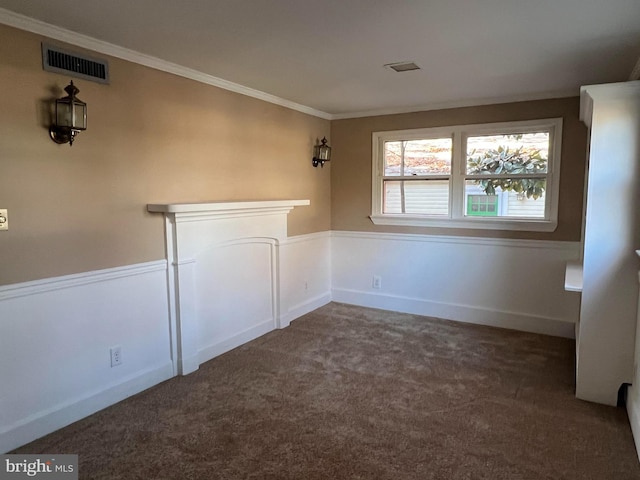 unfurnished room with dark colored carpet and crown molding