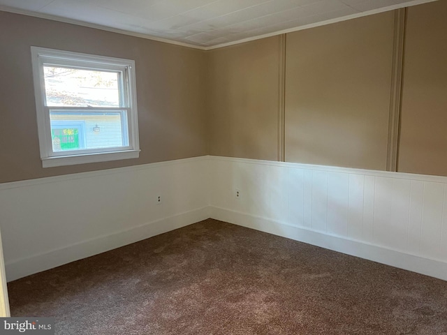 spare room with dark carpet