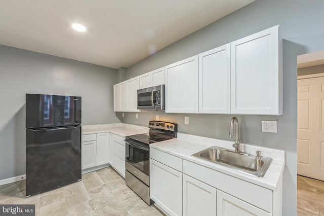 kitchen featuring white cabinetry, stainless steel appliances, and sink