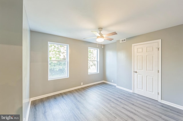 spare room featuring light hardwood / wood-style flooring and ceiling fan