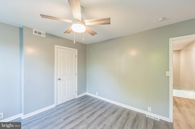 spare room featuring light hardwood / wood-style floors and ceiling fan