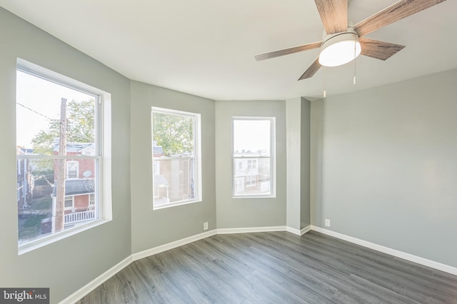 unfurnished room featuring ceiling fan and dark hardwood / wood-style flooring