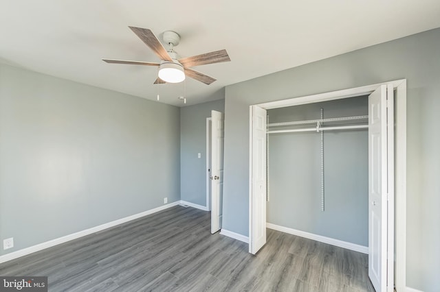 unfurnished bedroom featuring a closet, ceiling fan, and hardwood / wood-style floors