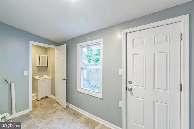 doorway to outside featuring sink and vaulted ceiling