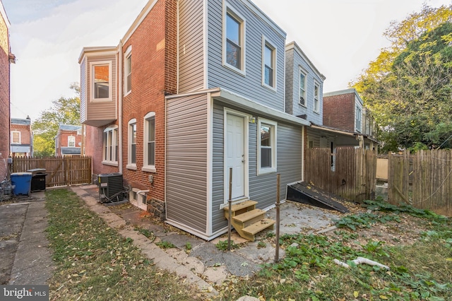 rear view of property featuring central AC