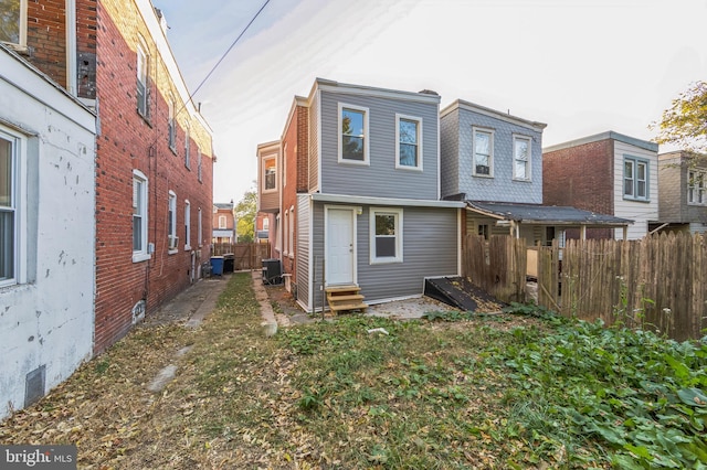 rear view of property featuring cooling unit