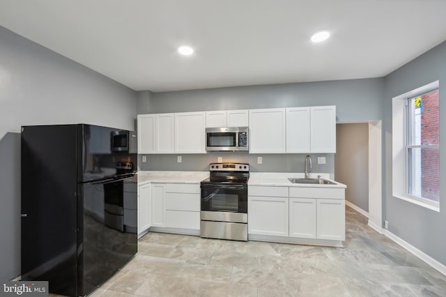 kitchen featuring stainless steel appliances, sink, and white cabinets